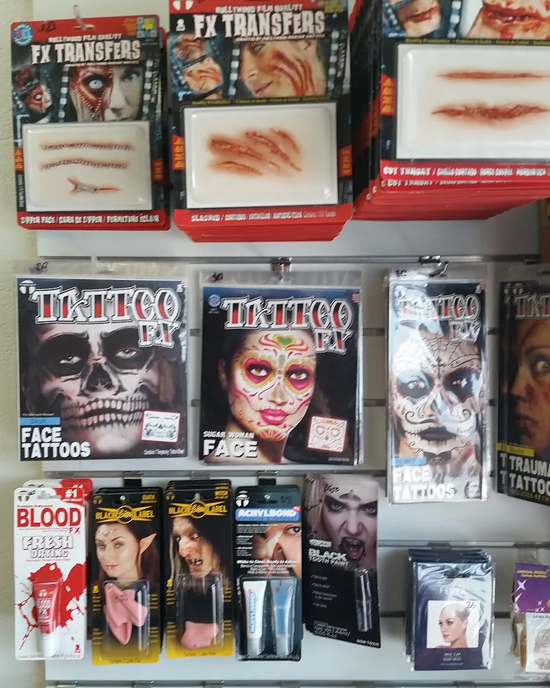 Wall of special effects makeup in the shop: wound transfers, face tattoo kits, fake blood and teeth