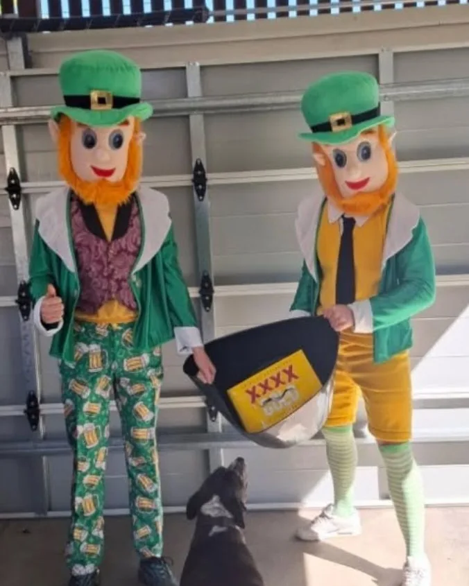 Two big-head leprechaun costumes in green suits and hats, ready for St Patrick's Day